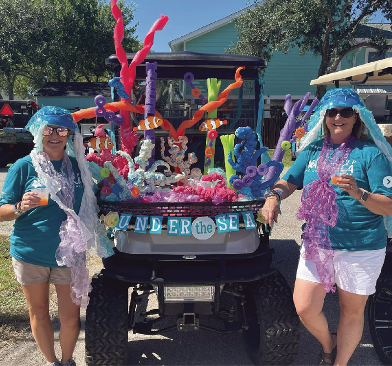 two people posting with an under the sea themes float wearing fun costumes and STAAR's Step Up America for ovarian cancer tshirts and enjoying a fun fundraising event to benefit low grade serous ovarian cancer lgsoc research